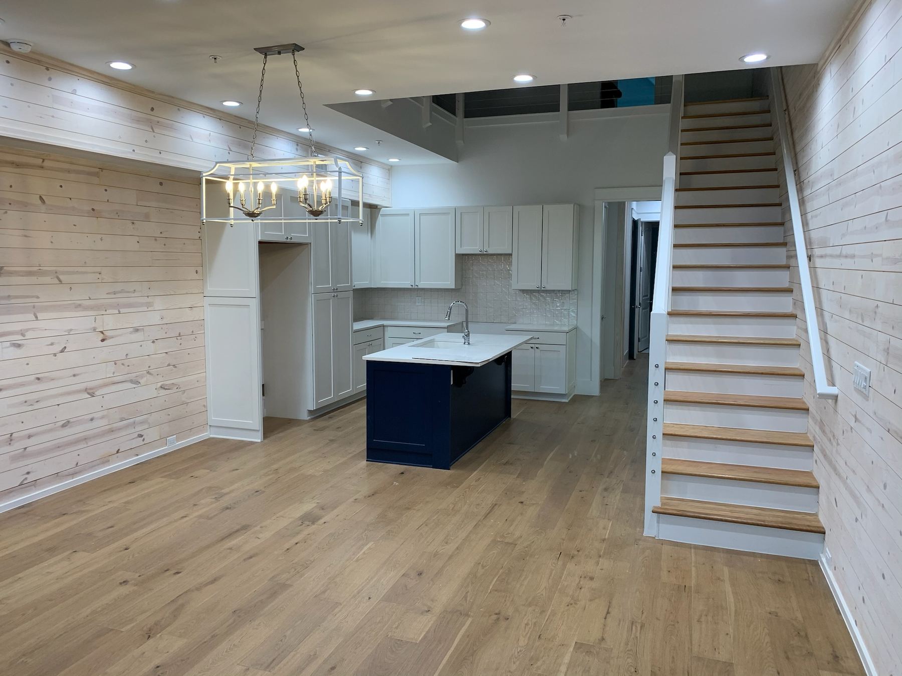 Kitchen remodel with wood plank walls and center island